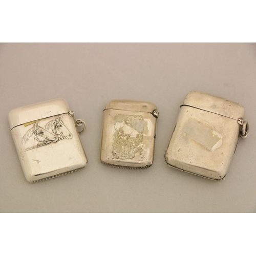 102 - A silver Vesta Case, Birmingham 1911, a smaller silver Vesta Case with crest, and a silver plated Ve... 