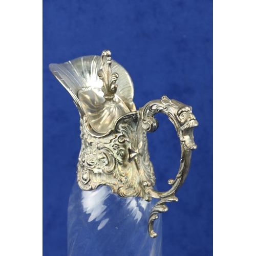 113 - A cutglass Claret Jug, c. 1900, with silver mounted top and handle, 31cms (12