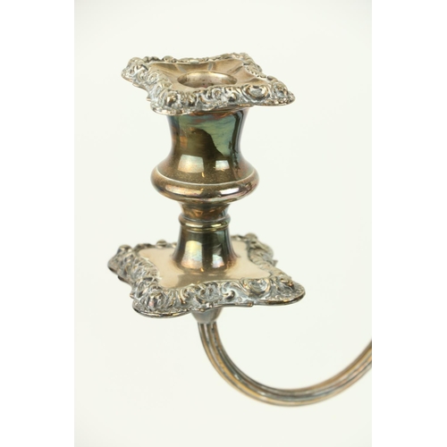 17 - A pair of two branch three light Sheffield silver plated Candelabra, each with leaf cast scroll arms... 