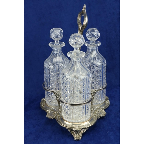 18 - A Sheffield silver plated Decanter Stand, with three cut glass decanters, each with prism stopper, 1... 