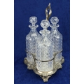 A Sheffield silver plated Decanter Stand, with three cut glass decanters, each with prism stopper, 1... 
