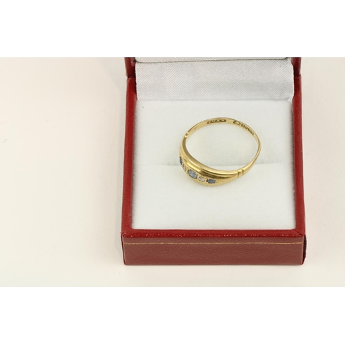 221 - An attractive 18ct gold Ladies Ring, with a straight band of eight diamonds recessed set, hallmarked... 