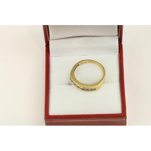 221 - An attractive 18ct gold Ladies Ring, with a straight band of eight diamonds recessed set, hallmarked... 