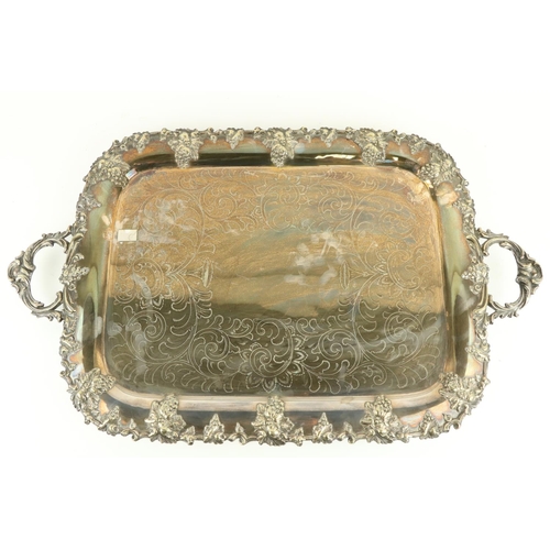 3 - A heavy silver plated two handled Tray, with vine cast edge and rococo style handles, raised on... 