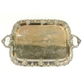 A heavy silver plated two handled Tray, with vine cast edge and rococo style handles, raised on... 