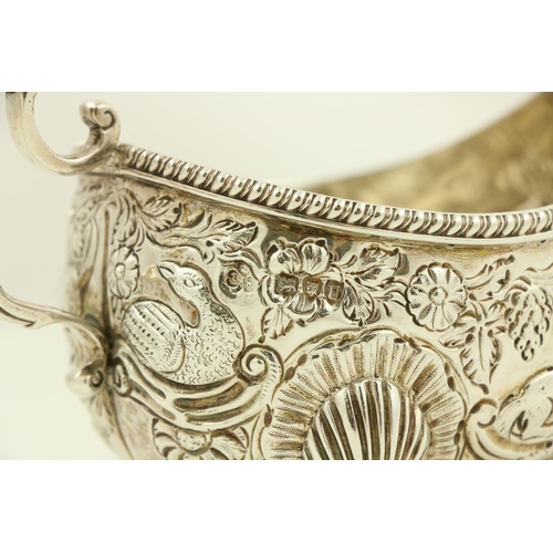 34 - A chased and embossed silver helmet shaped Cream Jug, London 1895 in the Irish 18th Century style, p... 