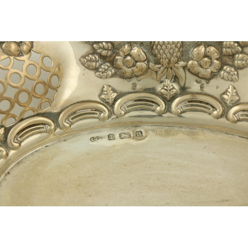 35 - An Edwardian embossed and pierced silver Bread Dish, Birmingham 1900, with shell and C scroll edge, ... 