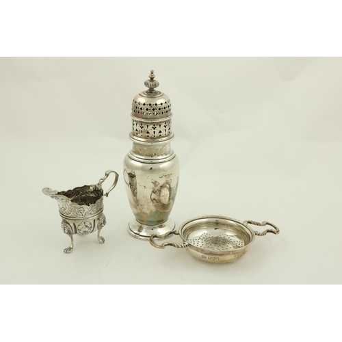 36 - A small Irish silver helmet shaped Cream Jug, by West and Son, Dublin, 1898, chased with birds, flow... 