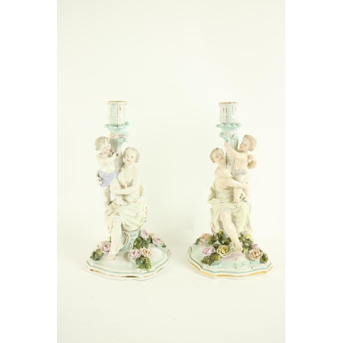 366 - A pair of Dresden porcelain Candlestick Groups, each with classical woman and child forming the stem... 