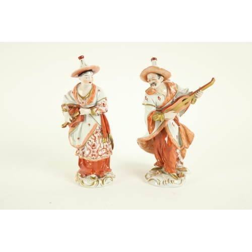 372 - A pair of Sitzendorf porcelain Figures, modelled as an Asian male and female musician, 20cms (8