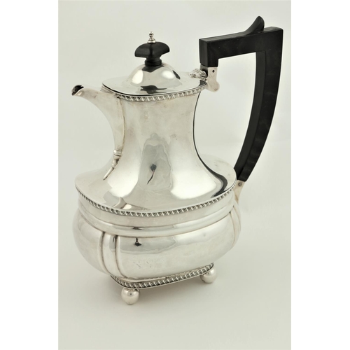 40 - A silver Coffee Pot, of oval ogee form, London 1938, with ebonised handle, 23cms (9