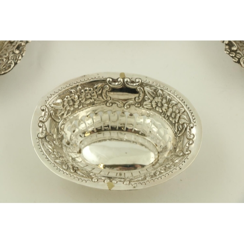 42 - A pair of embossed and pierced silver pear shaped Bon Bon Dishes; another oval ditto; and one pierce... 