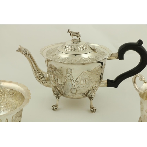 52 - A three piece Irish silver Tea Service, Dublin 1976, comprising: teapot with cow finial, the body ch... 