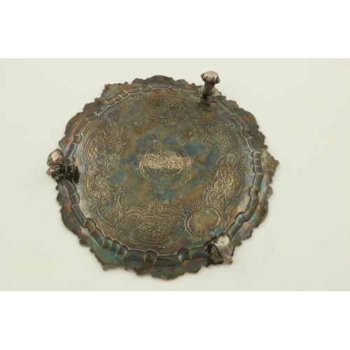 58 - An Irish Georgian period chased and crested silver Salver, within a leaf and shell chased scroll edg... 