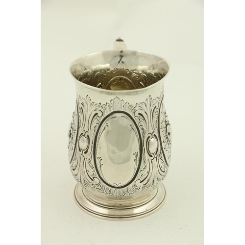 60 - A George III chased silver baluster shaped Tankard, London 1758 by Thos. Wright, chased with fruit a... 