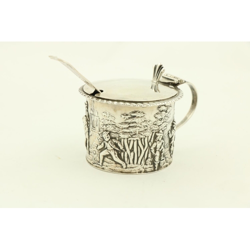 64 - An ornate Victorian silver Mustard, in the rococo style, with leaf cast handle and hinged cover, enc... 