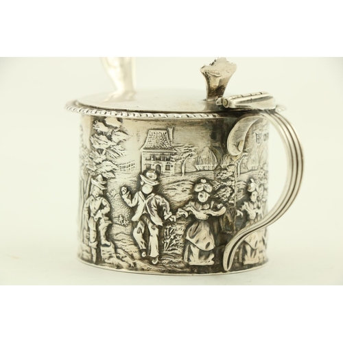 64 - An ornate Victorian silver Mustard, in the rococo style, with leaf cast handle and hinged cover, enc... 