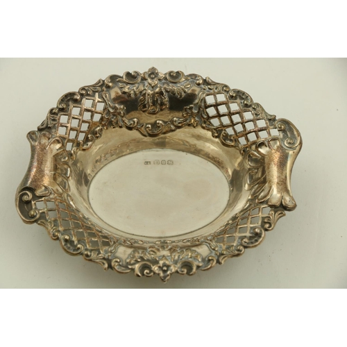 67 - A pair of circular modern Chester silver Bon Bon Dishes, each with leaf moulded edge and spiral flut... 