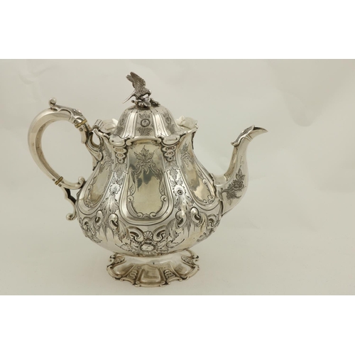 72 - A Victorian crested silver Teapot, London 1874, by Martin Hall & Co., the domed cover with a bir... 