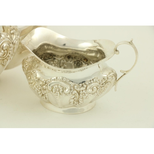 73 - A three piece silver Tea Service, Birmingham 1907, comprising an embossed oval teapot with hinged co... 