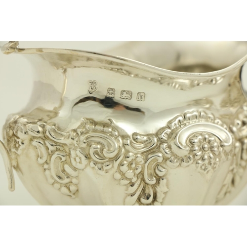 73 - A three piece silver Tea Service, Birmingham 1907, comprising an embossed oval teapot with hinged co... 