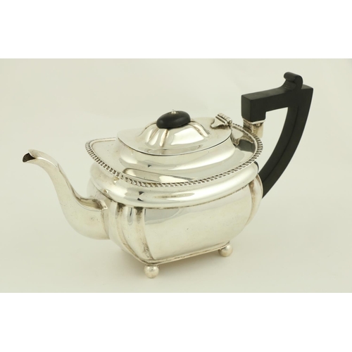 76 - A silver rectangular ogee shaped Teapot, Birmingham 1929, with bead edge and raised on four ball fee... 