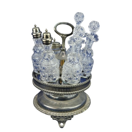 19 - A silver plated rotating Cruet Stand, with six cutglass bottles, some with silver plated mounts. (1)... 