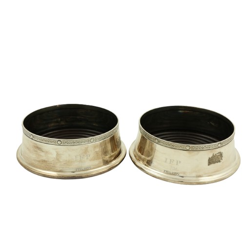 31 - A pair of modern Irish silver Wine Coasters, Dublin c. 1999, each with a Celtic design rim and woode... 