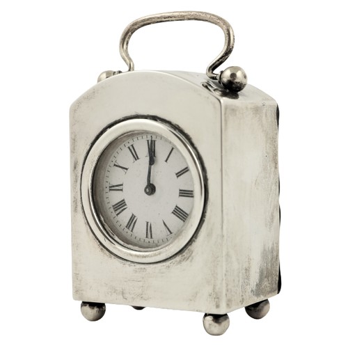 53 - An arch top silver cased Carriage Clock, London 1927, with French movement, the swing handle above a... 