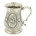 A George III chased silver baluster shaped Tankard, London 1758 by Thos. Wright, chased with fruit a... 
