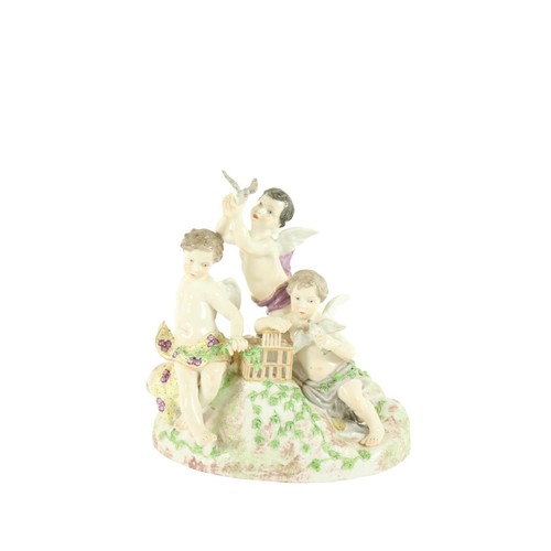 369 - A Dresden porcelain Group, c. 1900, modelled with three cherubs playing with doves, on an ivy clad b... 