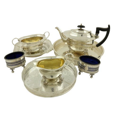 11 - A three piece silver plated Tea Service, 20th Century; together with a pierced and silver plated Tra... 