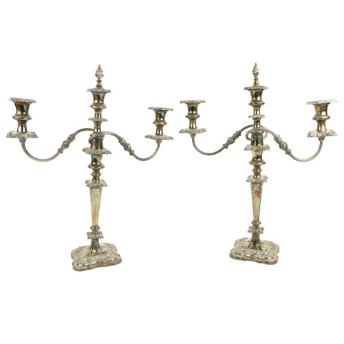 17 - A pair of two branch three light Sheffield silver plated Candelabra, each with leaf cast scroll arms... 