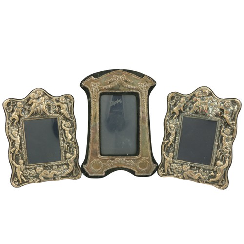26 - A pair of modern silver Photograph Frames, each with classical cherubs in relief, 20cms x 14cms (8