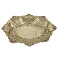 An Edwardian embossed and pierced silver Bread Dish, Birmingham 1900, with shell and C scroll edge, ... 