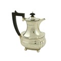 A silver Coffee Pot, of oval ogee form, London 1938, with ebonised handle, 23cms (9