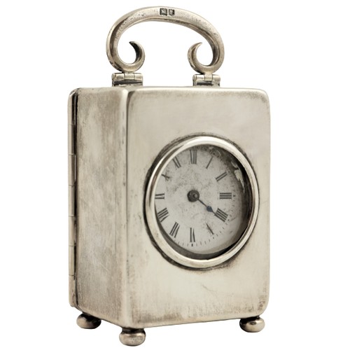 54 - A miniature silver Carriage Clock, London 1912, with swing handle, lever movement and enamel dial wi... 