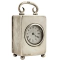 A miniature silver Carriage Clock, London 1912, with swing handle, lever movement and enamel dial wi... 