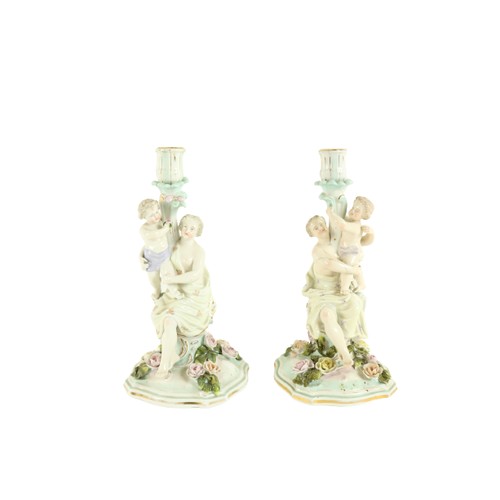 366 - A pair of Dresden porcelain Candlestick Groups, each with classical woman and child forming the stem... 