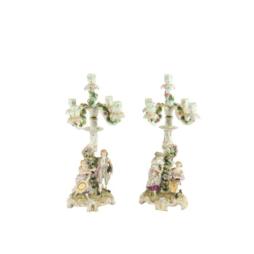 376 - A pair of Sitzendorf porcelain flower encrusted four branch five-light Candelabra, each with an asym... 