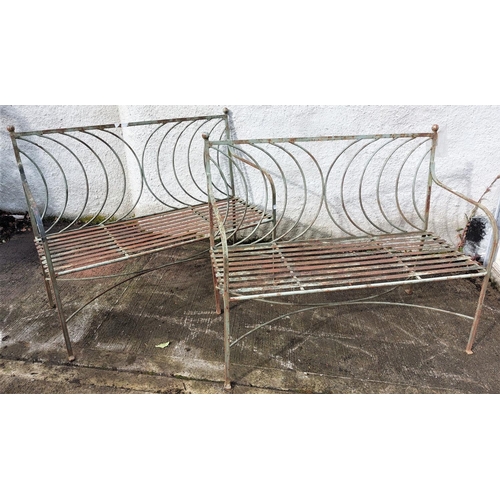 1015 - A pair of quality and ornate Victorian wrought iron two seater Garden Benches, with half moon design... 