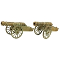 A pair of attractive brass Cannon Carriages, O.R.M., embossed design, each on spoked wheels, approx.... 
