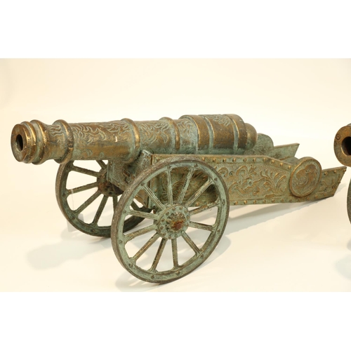609 - A pair of attractive brass Cannon Carriages, O.R.M., embossed design, each on spoked wheels, approx.... 