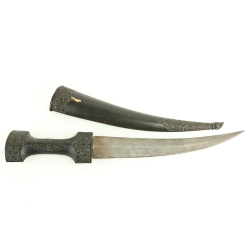 610 - A fine quality 19th Century Middle Eastern Ceremonial Dagger, the plain steel blade housed in a carv... 