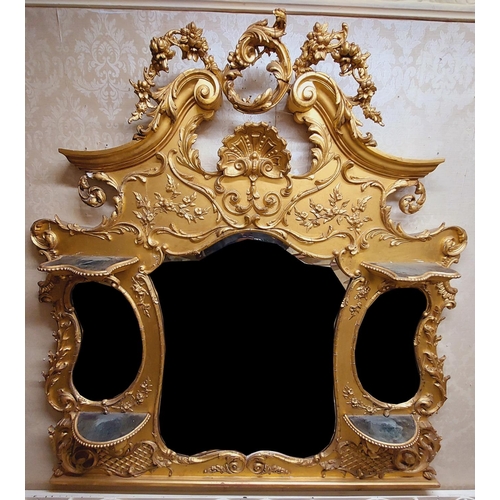 625 - A gilt Overmantel, late 19th Century / early 20th Century, the leaf scroll crest issuing floral swag... 