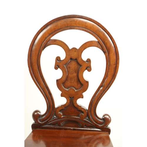 628 - A pair of Victorian mahogany Hall Chairs, each with open work cartouche shaped back above a solid se... 