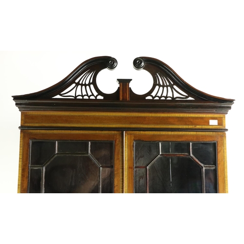 645 - An Edwardian inlaid and crossbanded mahogany Bureau Bookcase, the pierced and moulded swan neck pedi... 