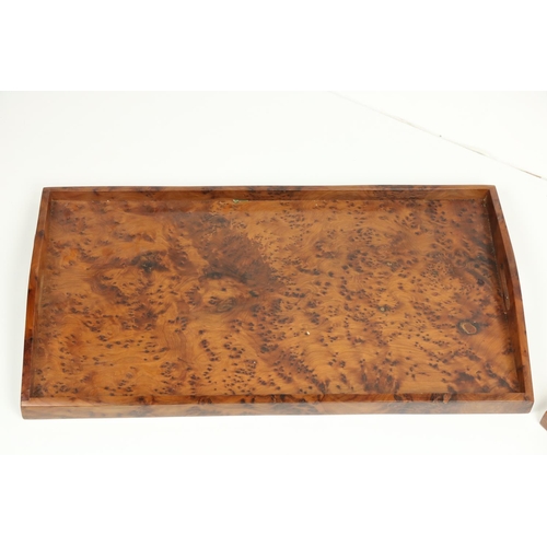 660 - An attractive pair of elongated burr maple Serving Trays, with pierced handles and arched sides, app... 