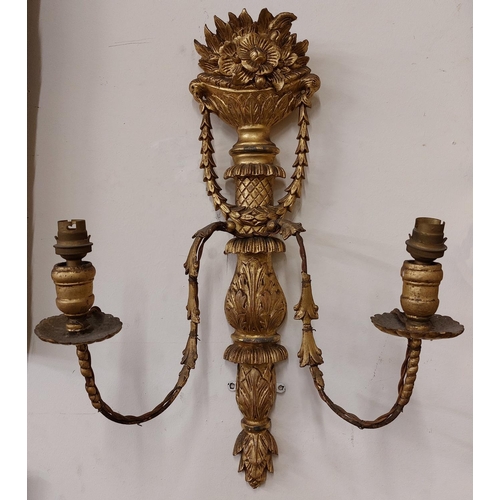 671 - A pair of carved giltwood two branch Wall Lights, each crested with a vase of flowers, issuing swags... 