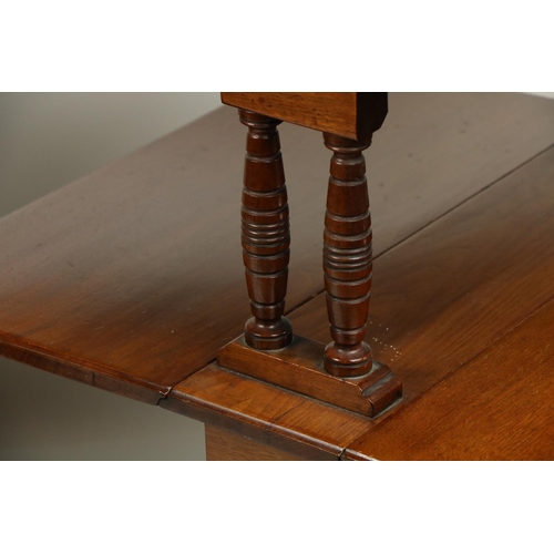 711 - An unusual pair of Edwardian walnut two tier Sutherland Tables, each tier with two rectangular flaps... 